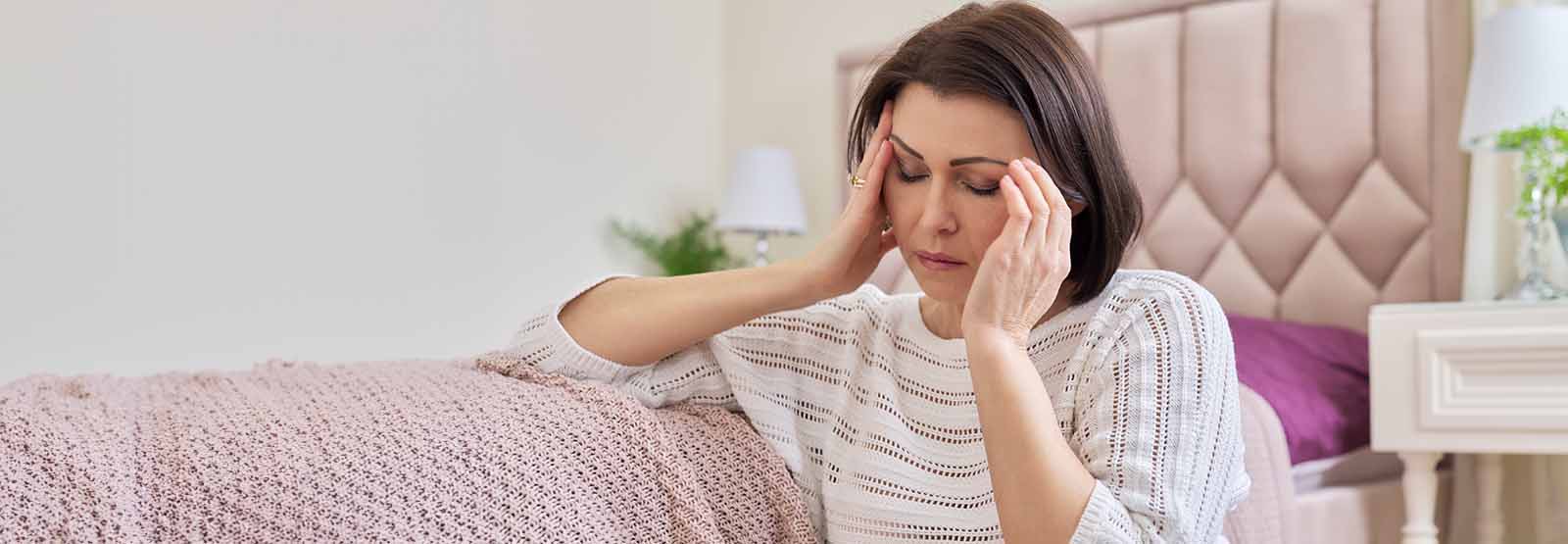 Distressed lady with head in hands